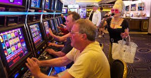 Live casino dealer at blackjack table with multi-camera setup